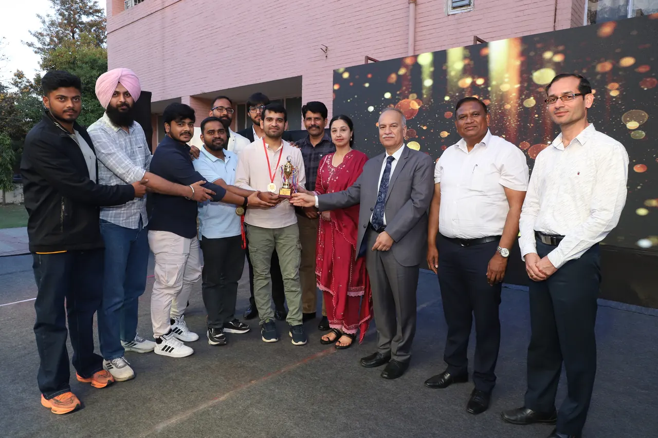 A team receives a trophy from the guests