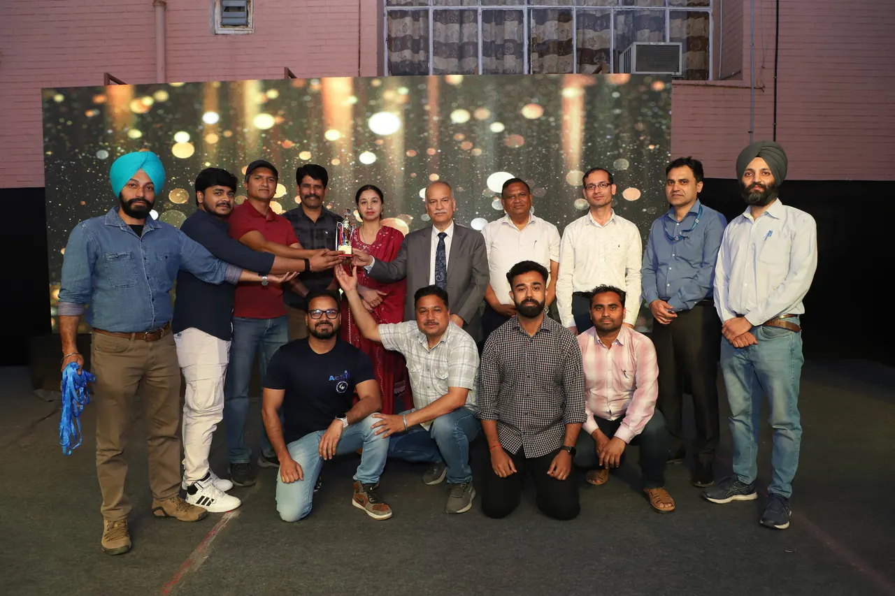A team poses with its trophy and the guests