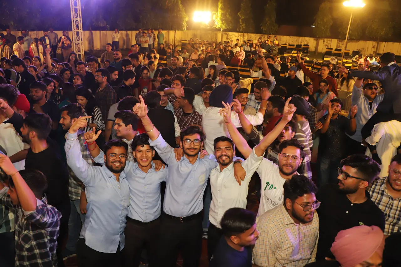 A crowd dances and cheers at the night event