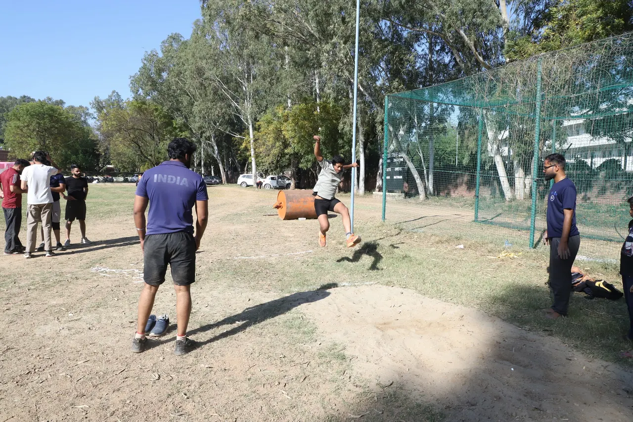 An athlete competes in a field event as others look on