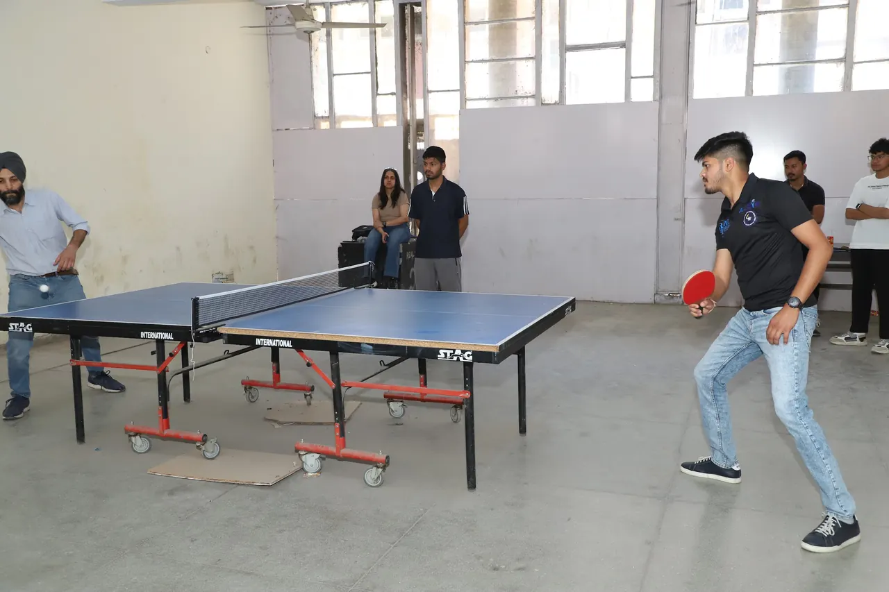 Players in a table tennis match in the indoor hall