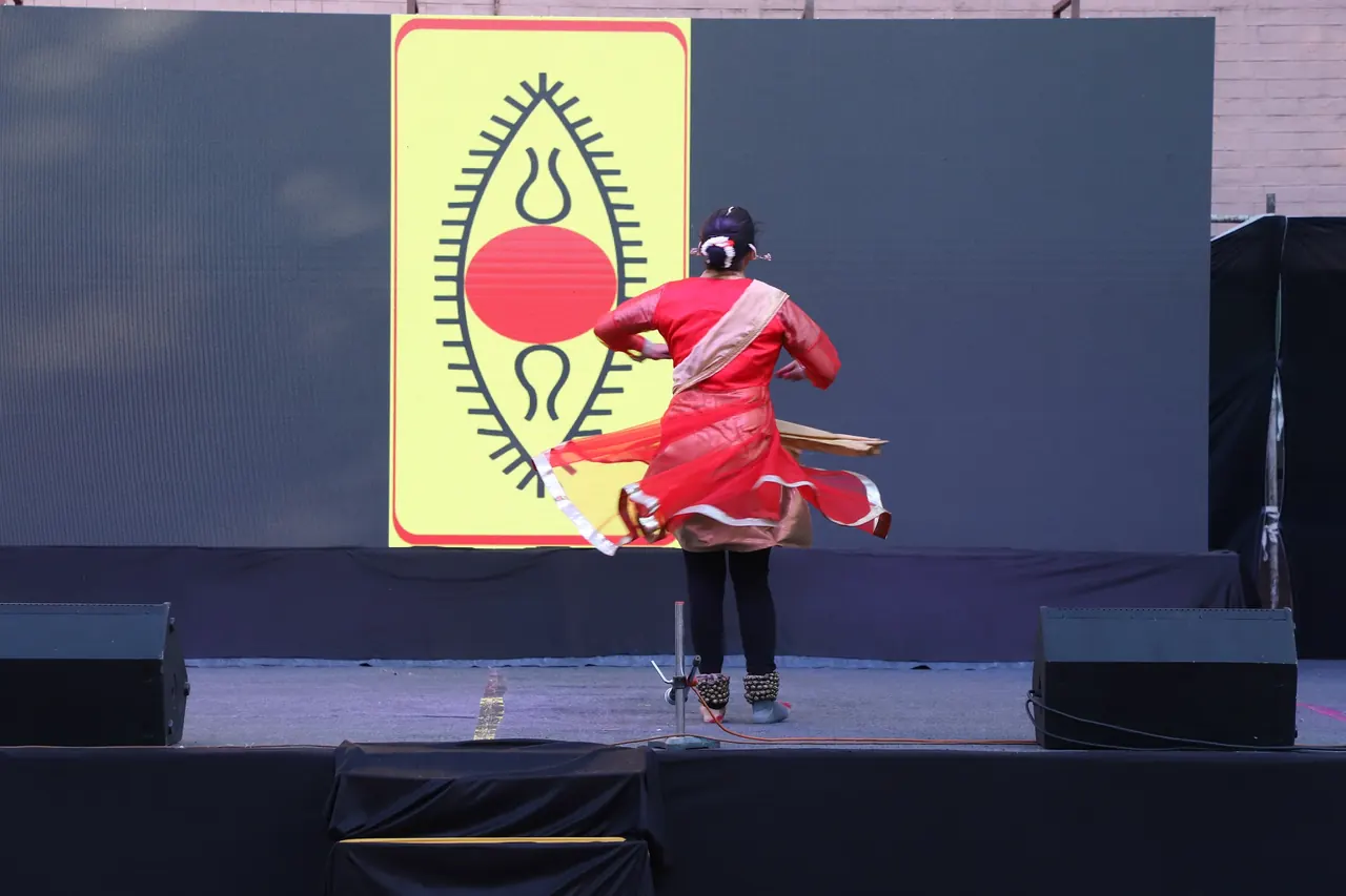 Classical dancers in red perform in a line