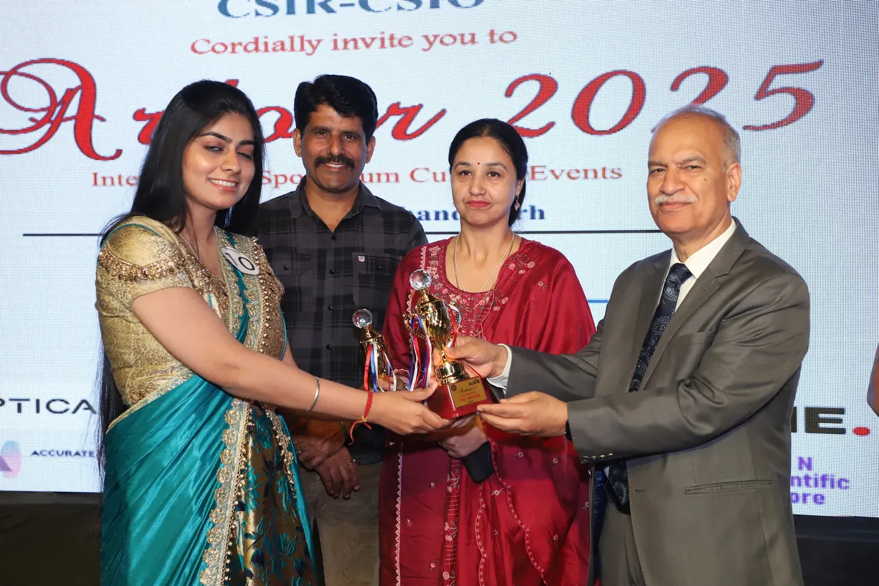 An award is presented on stage in front of the Ardour 2025 backdrop