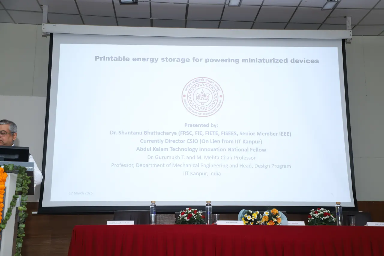 A presentation slide projected on a screen in an auditorium