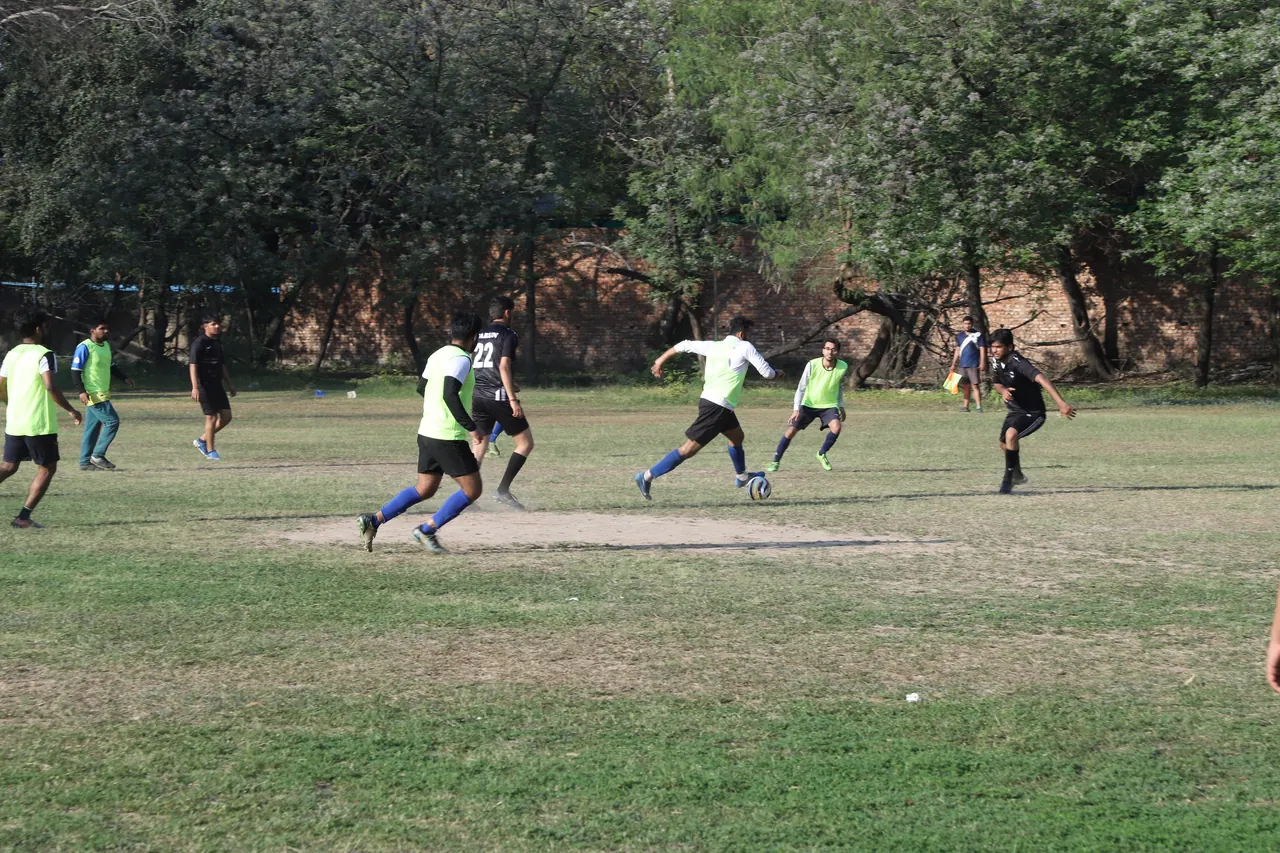 Players chase the ball during a football match