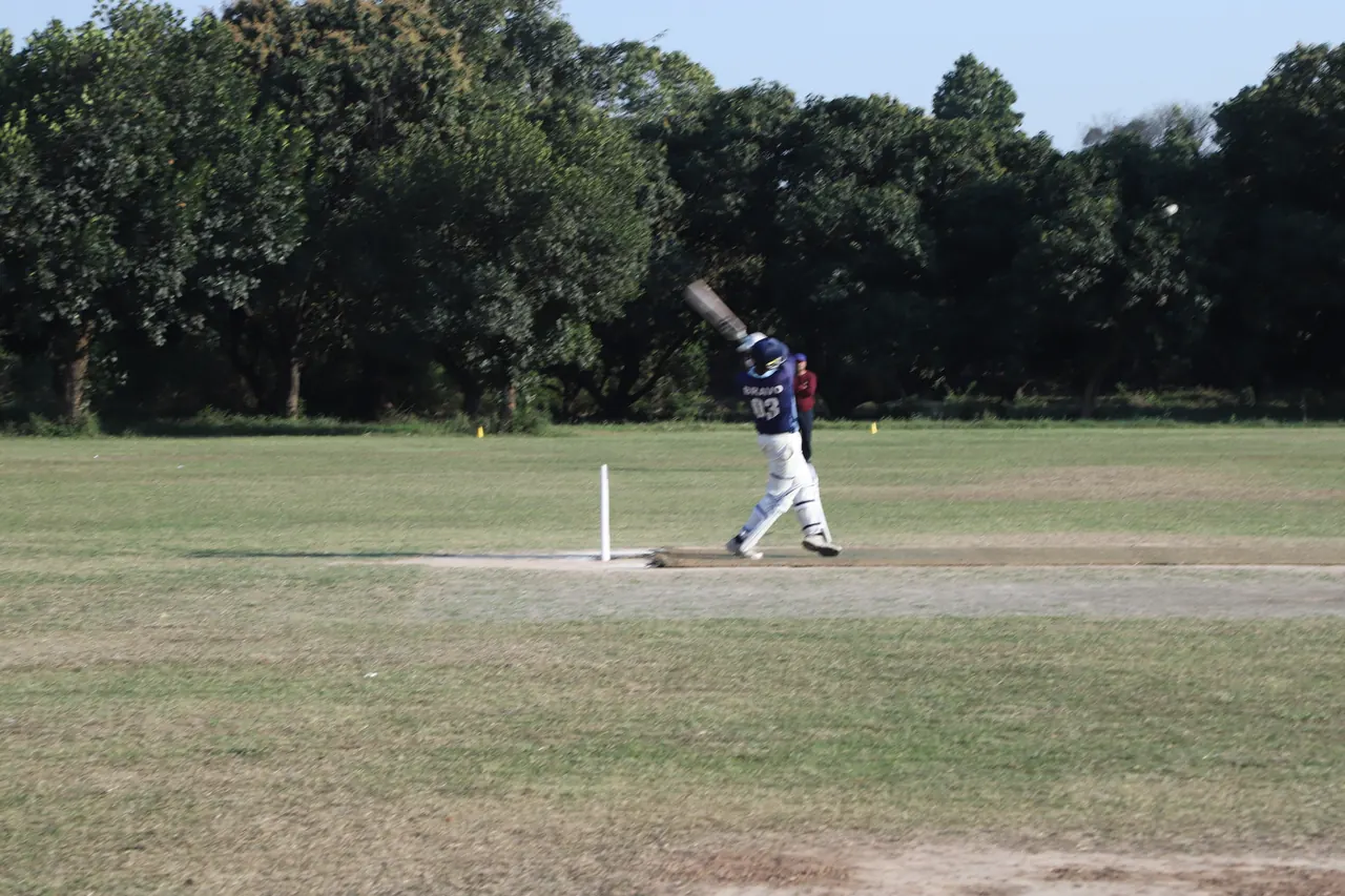 A bowler runs in on the cricket ground