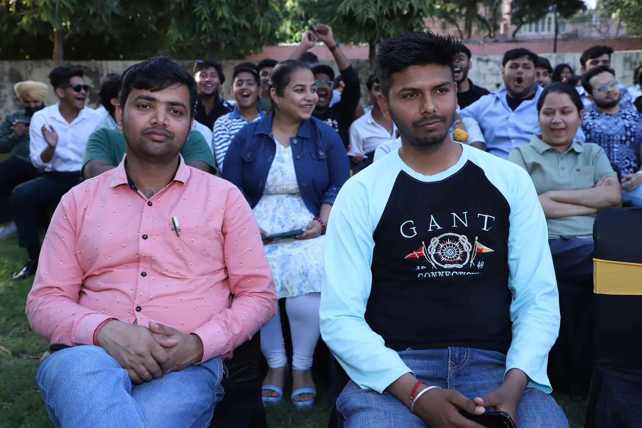 Audience members seated in rows at the outdoor programme
