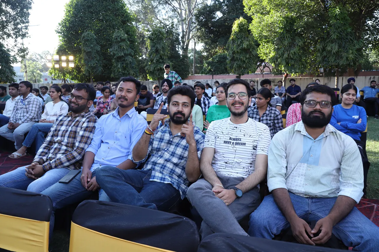 Audience members seated on the lawn for the programme
