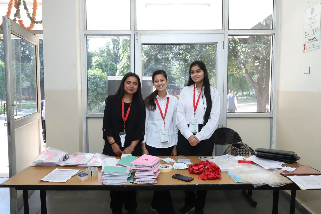 Volunteers stand behind the registration desk at Reminisce 2025