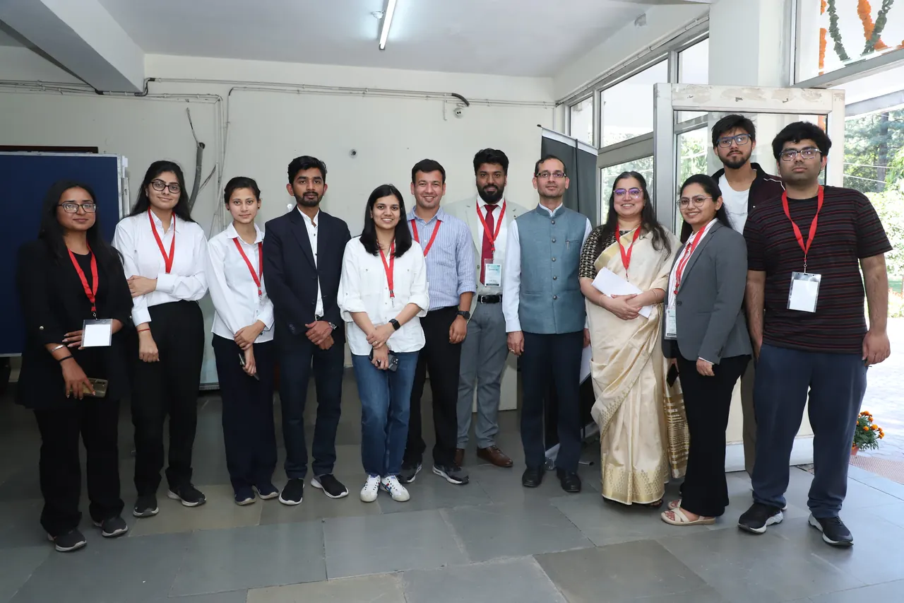 Participants and organisers pose for a group photograph indoors