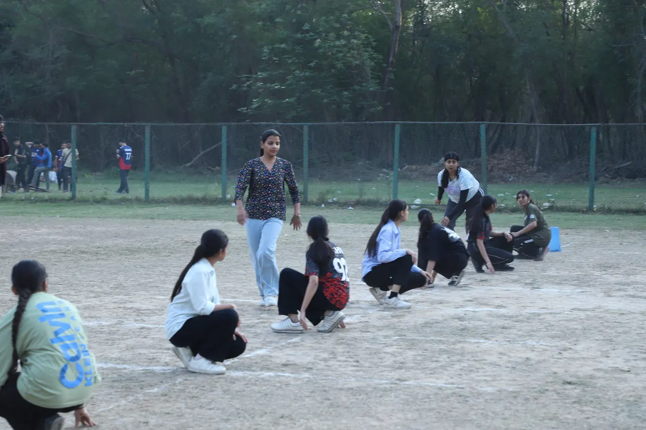 Kho kho players crouched in a line