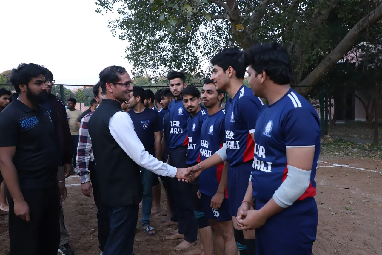 Kabaddi players shake hands with officials before a match
