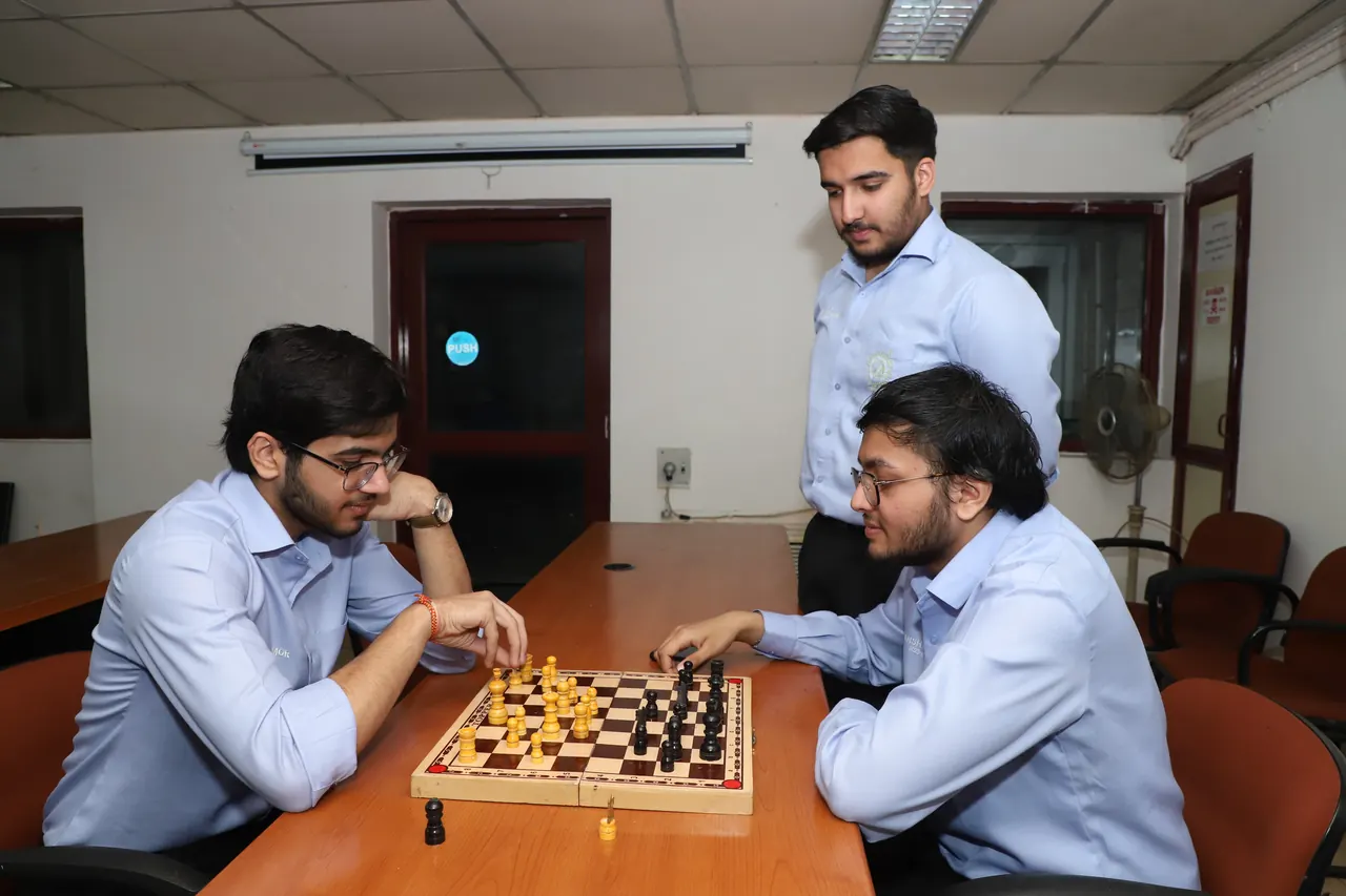 Two players concentrate over a chessboard