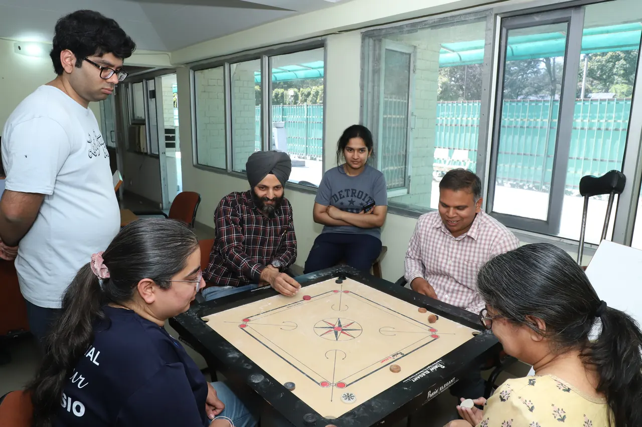 A carrom match with spectators watching
