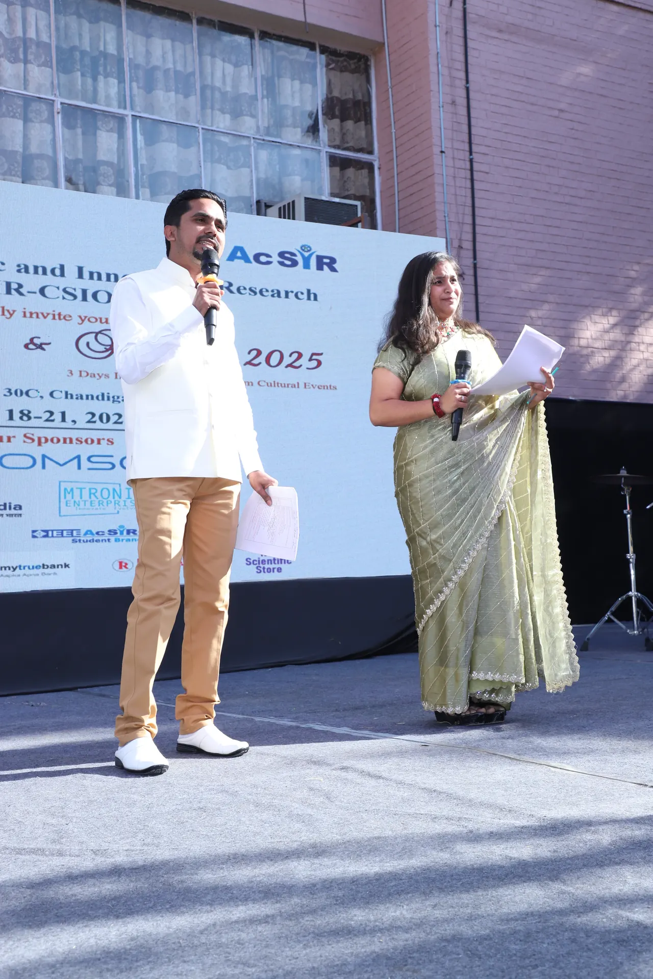 Two hosts on the outdoor stage