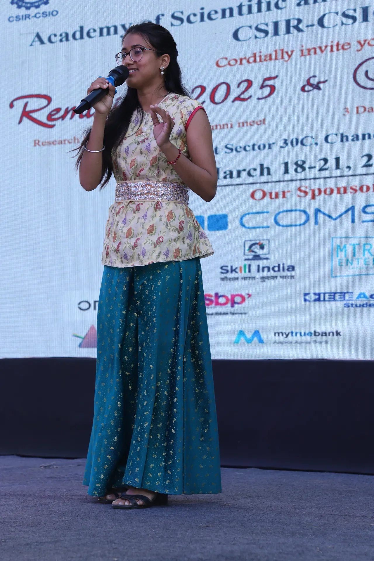 A performer sings on the outdoor stage