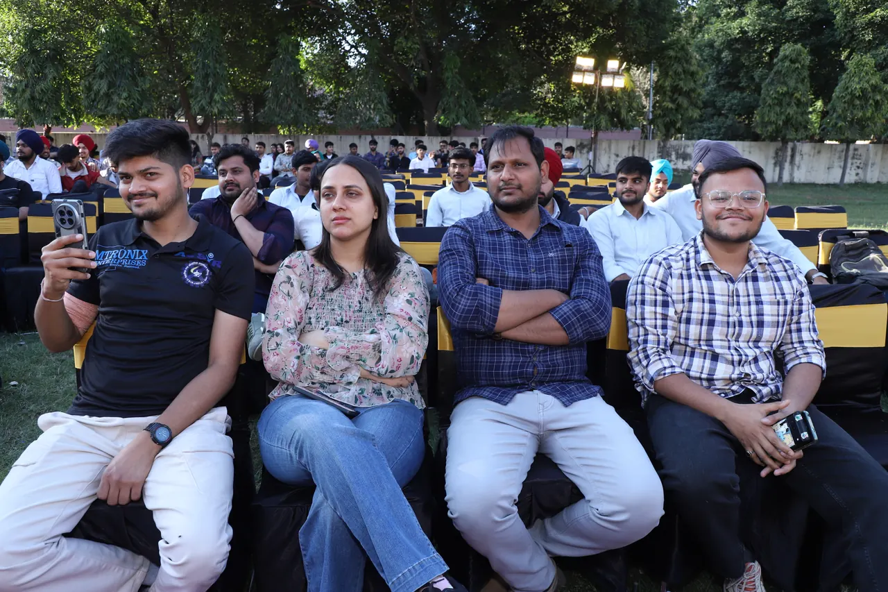 Audience members seated on the lawn