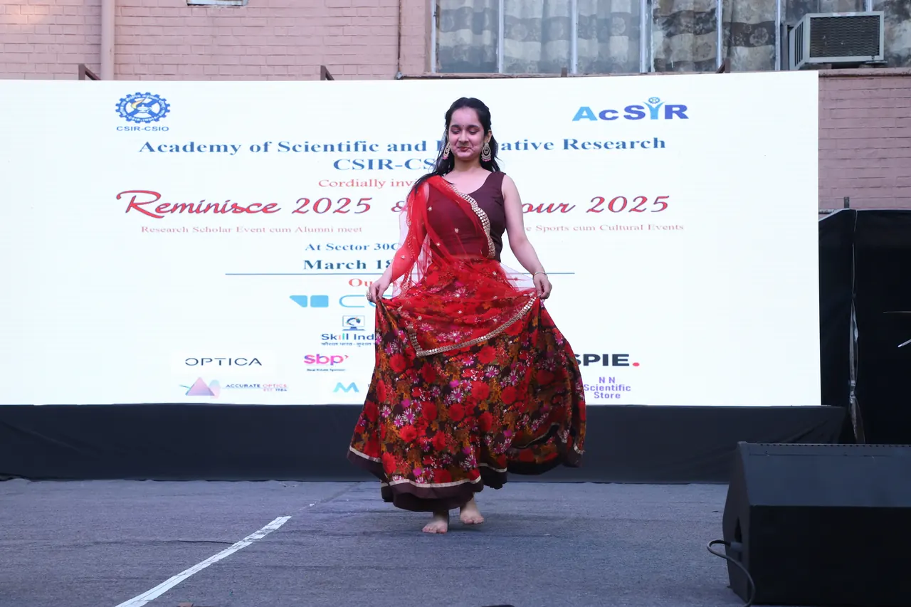 A dancer in a red skirt performs on stage