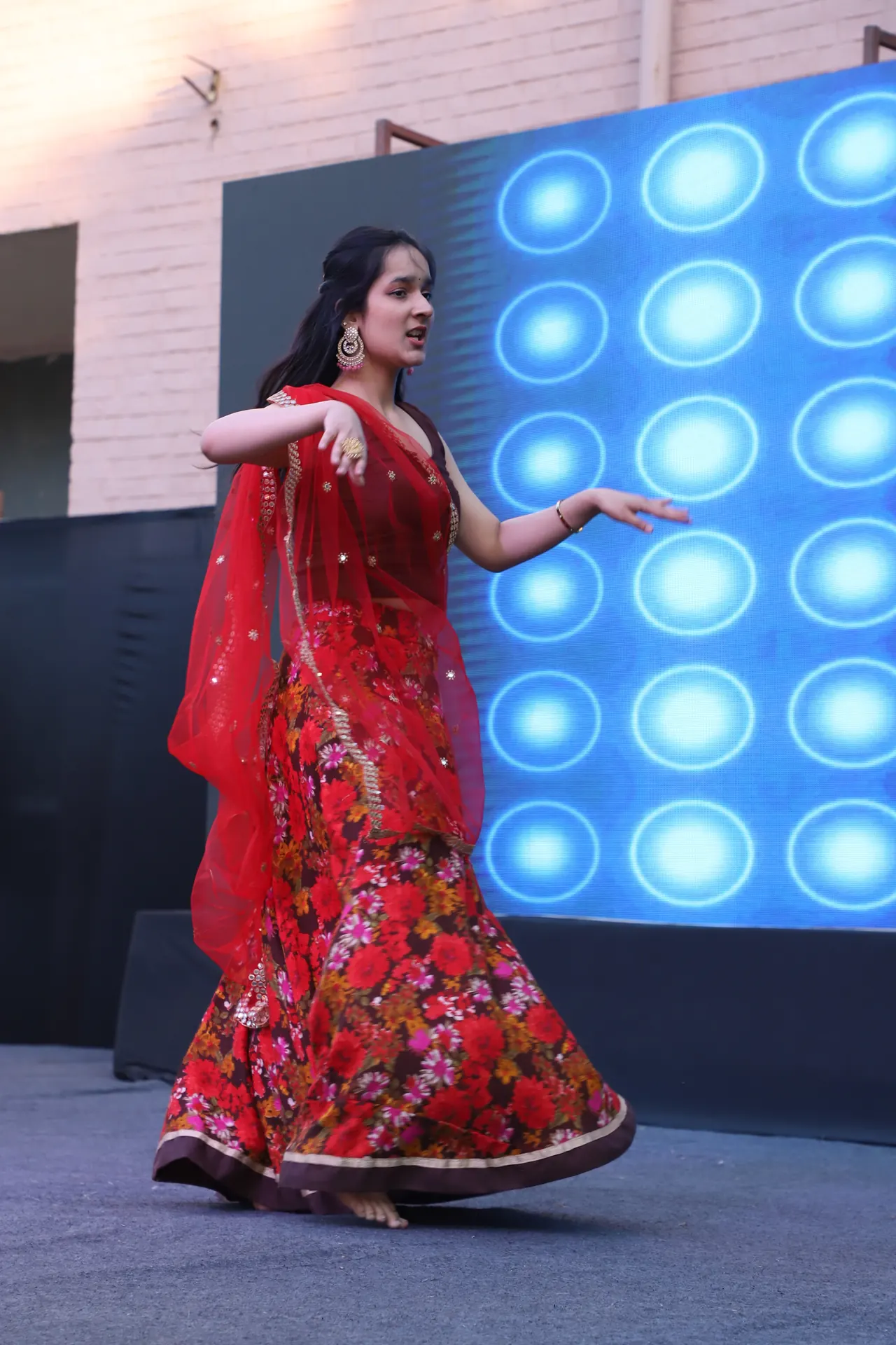 A dancer in red turns on stage