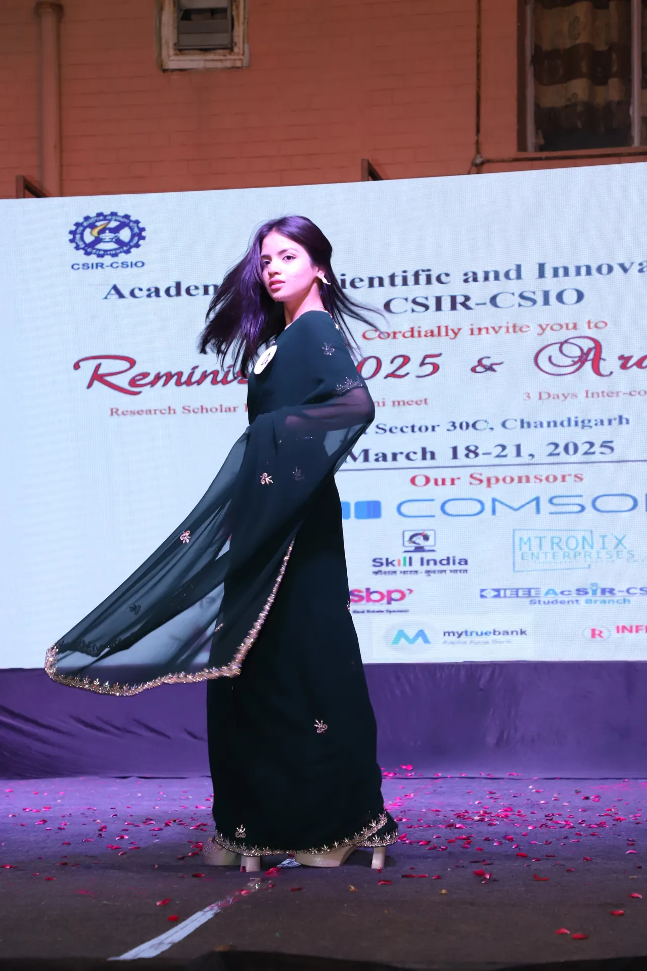 A participant in a dark green outfit on the ramp