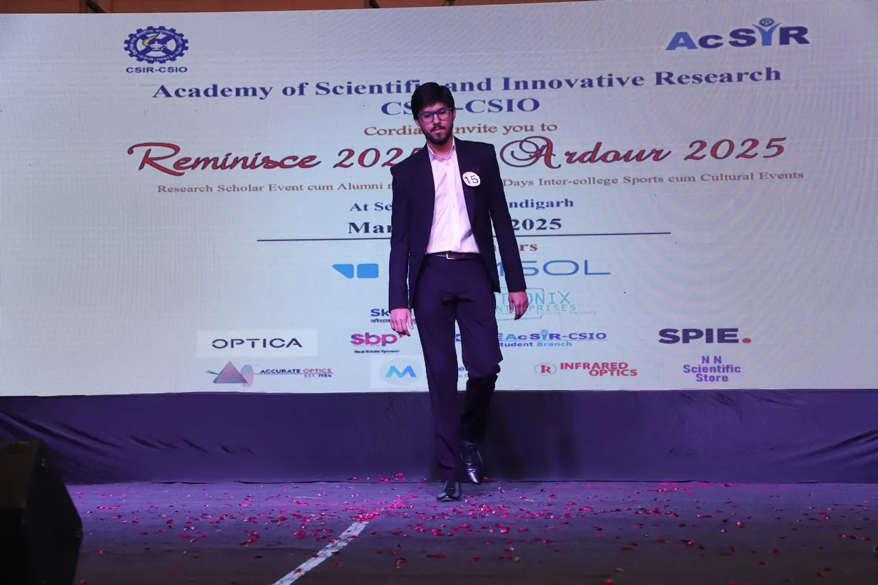 A participant in a suit walks the ramp