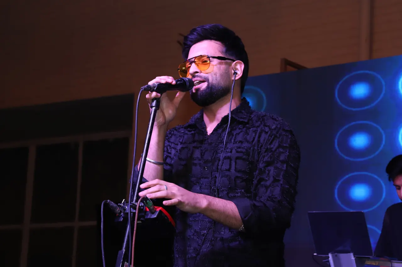 A singer performs at the microphone at night