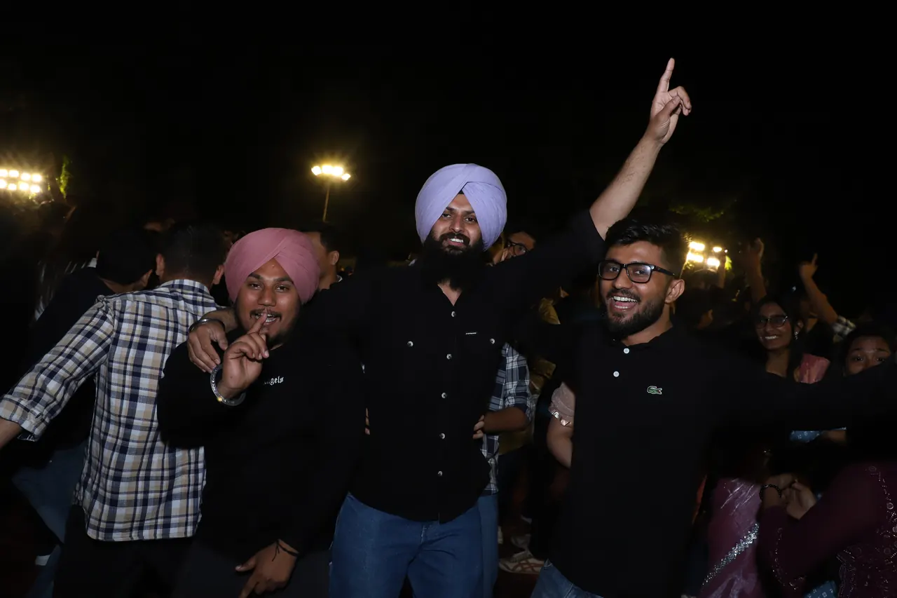 Participants cheer and dance at the night event