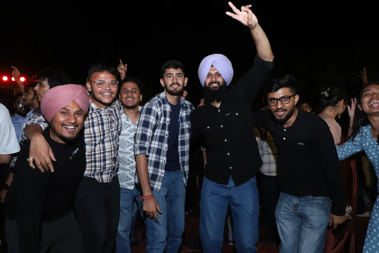 A group of friends cheers at the night event