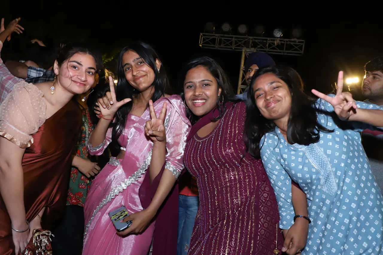 Friends pose and cheer at the night event