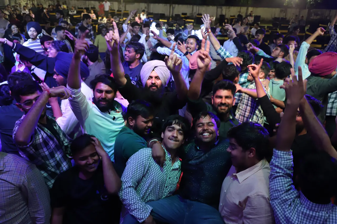 A dense crowd dances at the night event