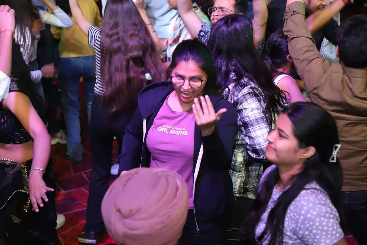 Participants dance and smile in the crowd