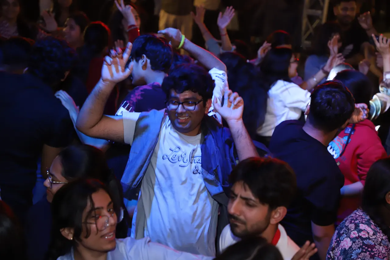 Participants dance in the crowd at night