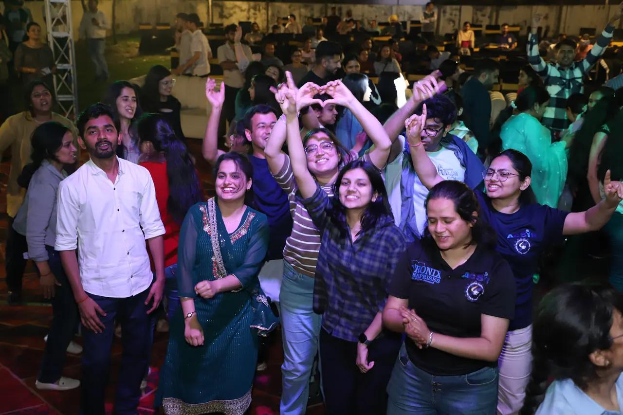A group dances together at the night event