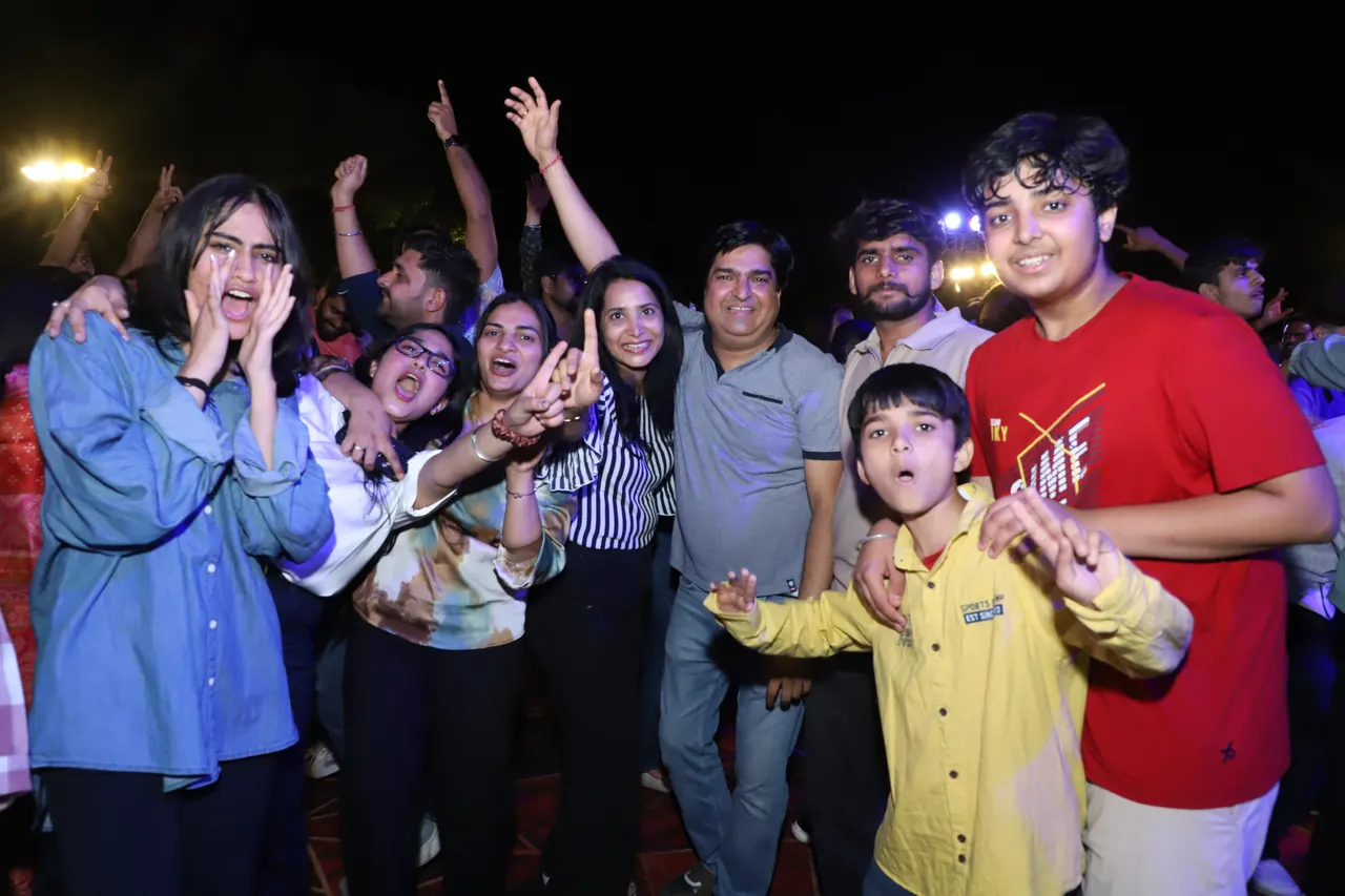 A cheering group of participants at night