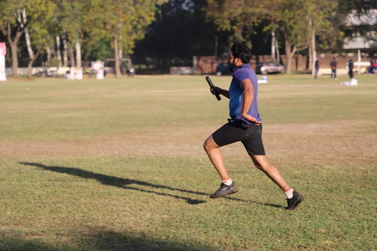 An athlete sprints across the ground